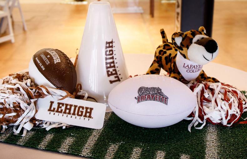 Lehigh University and Lafayette College swag sitting on a white table