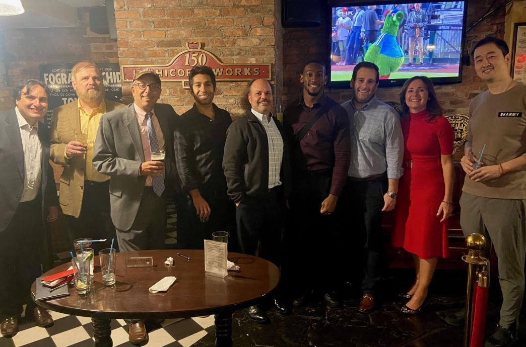 members of the Lehigh Lawyers Association posing together in a dimly lit pub