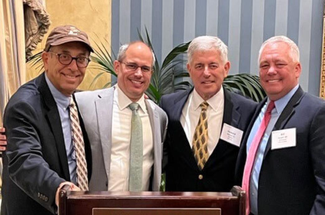 Four gentlemen standing behind a Lehigh University podium