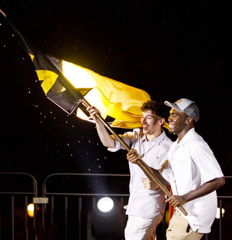 Two men carrying flag