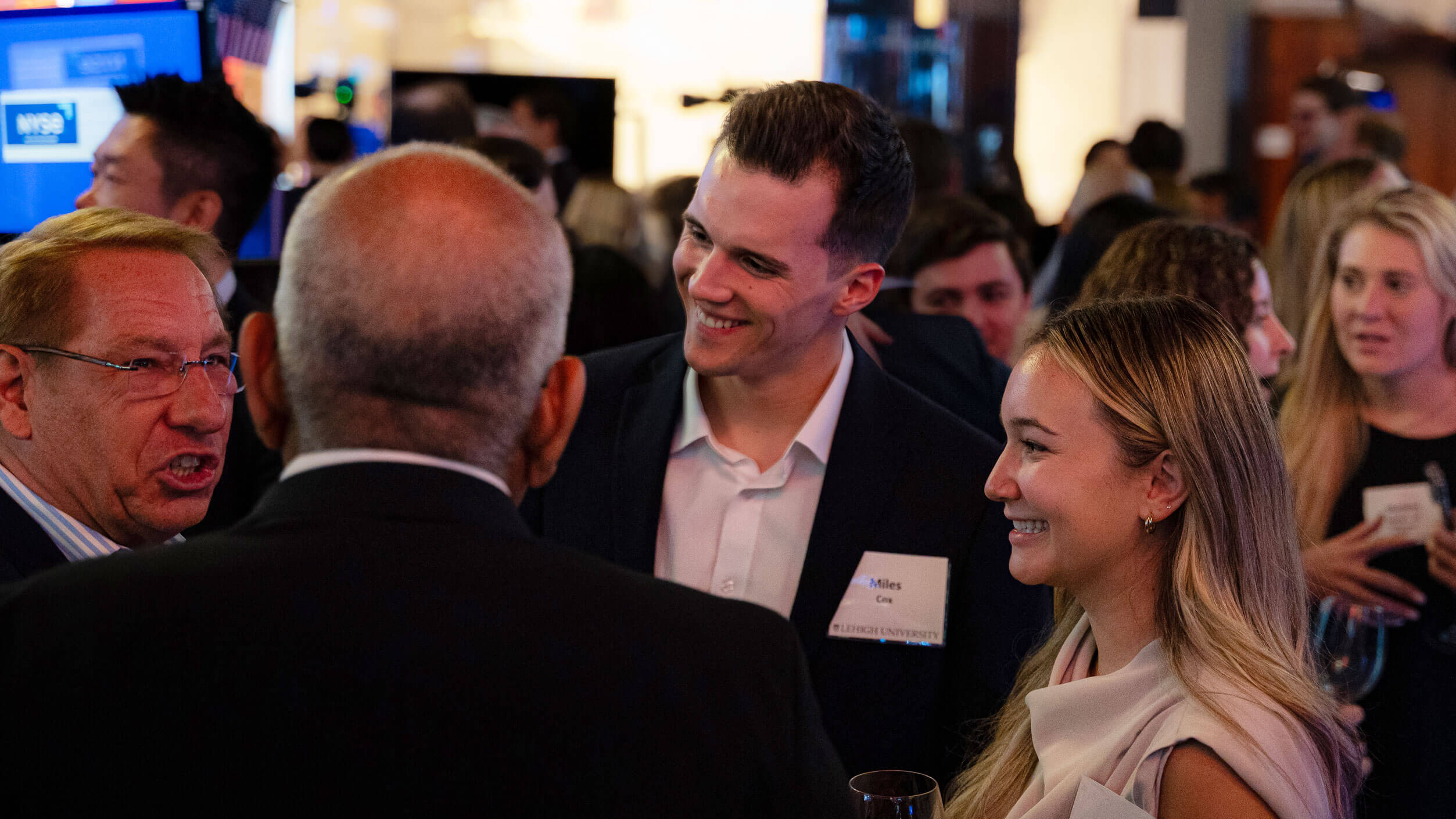 People dressed in business clothing engrossed in a conversation