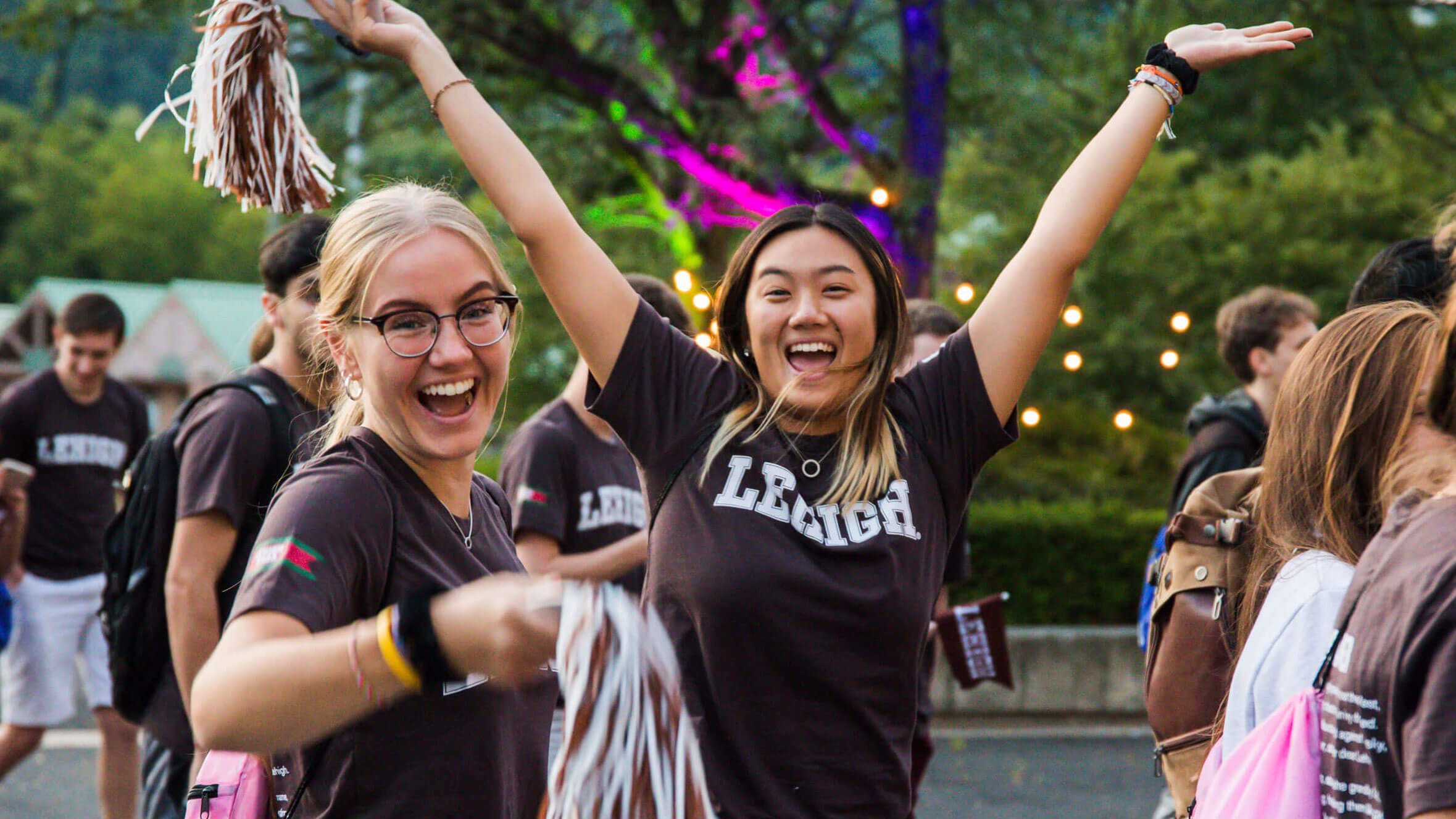 Two women in their Lehigh brown and white celebrating and smiling
