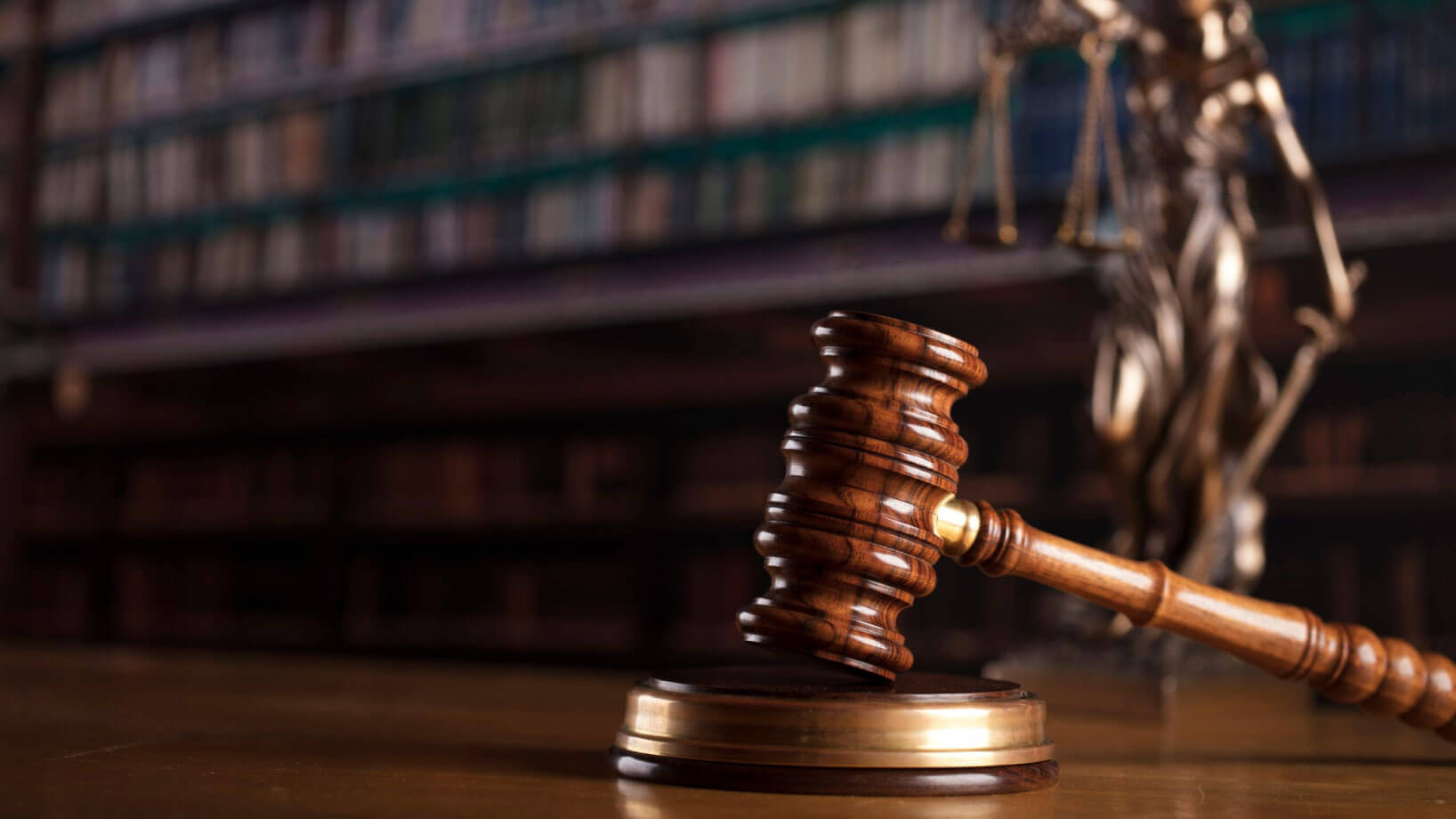 Wooden gavel resting on a wooden desk