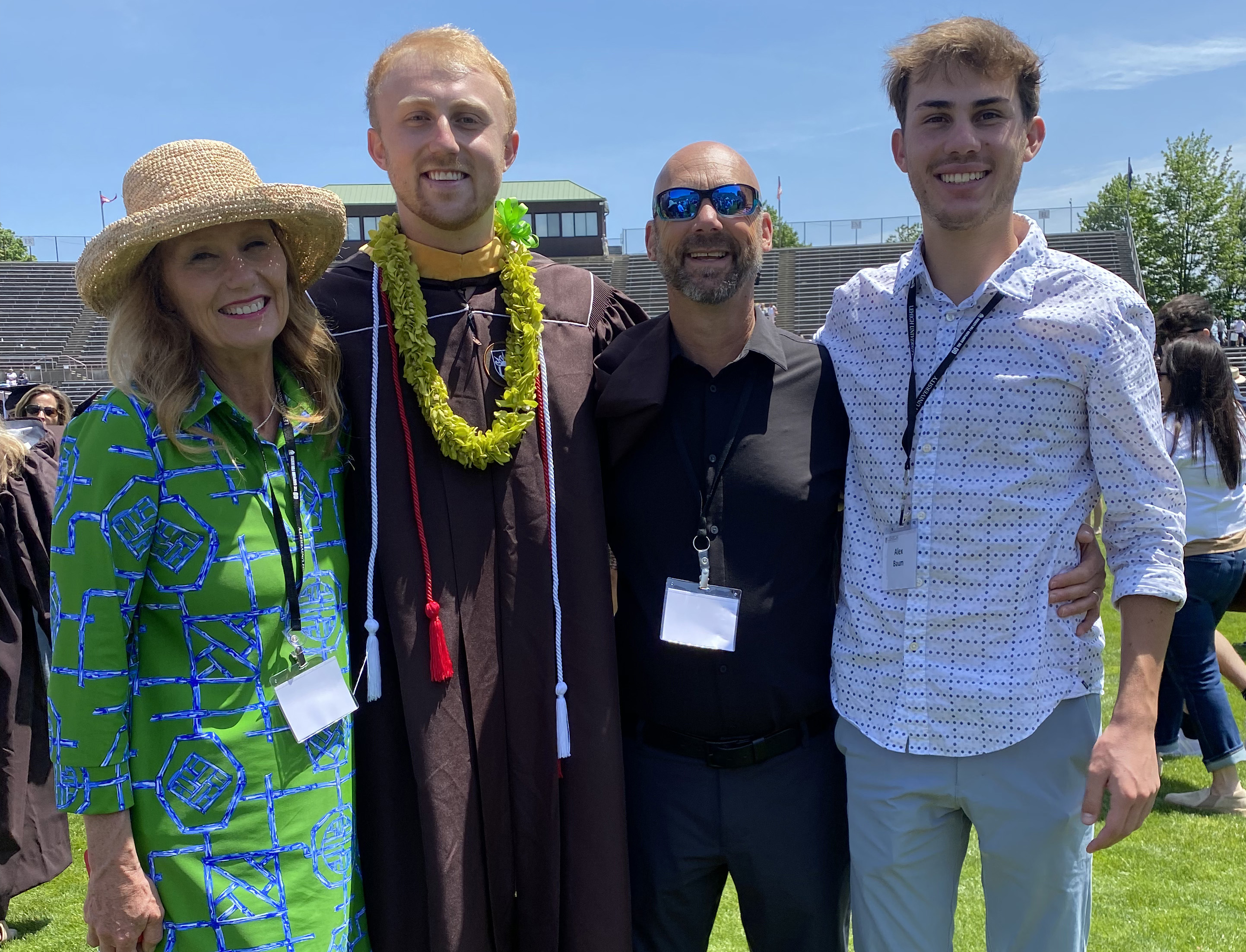 Karen and Garrett Baum taking a family photo with their children at their son's graduation