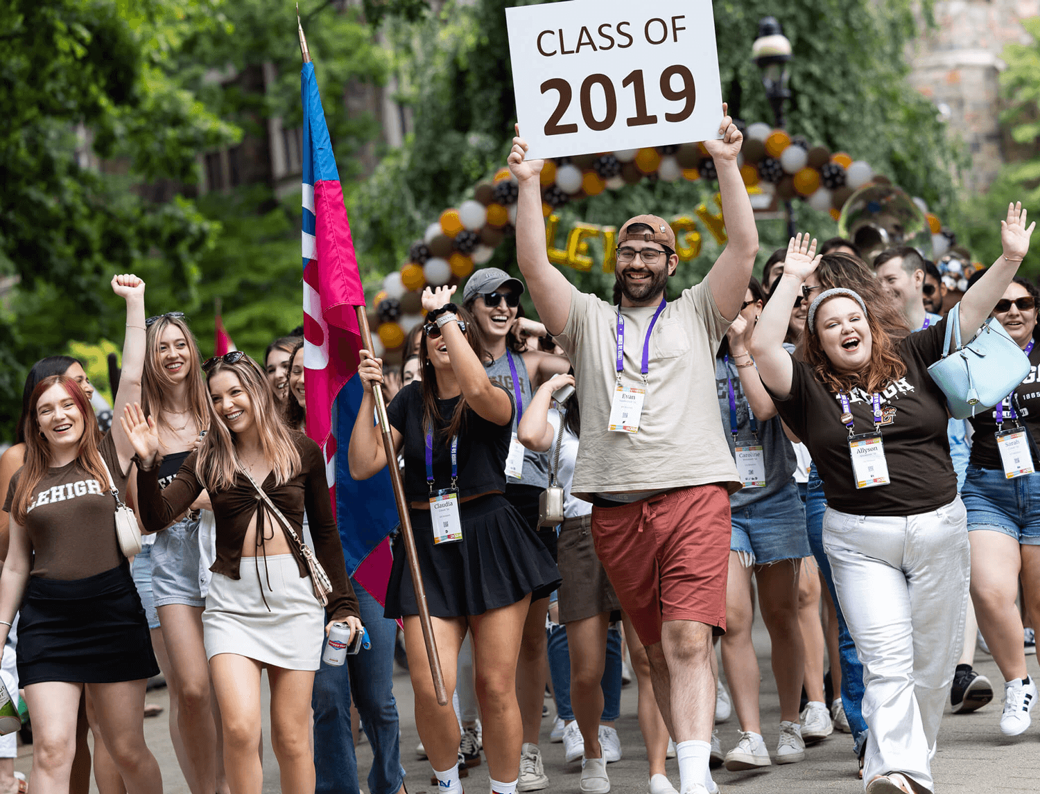 Class of 2019 parades at reunion holding a sign with their class year