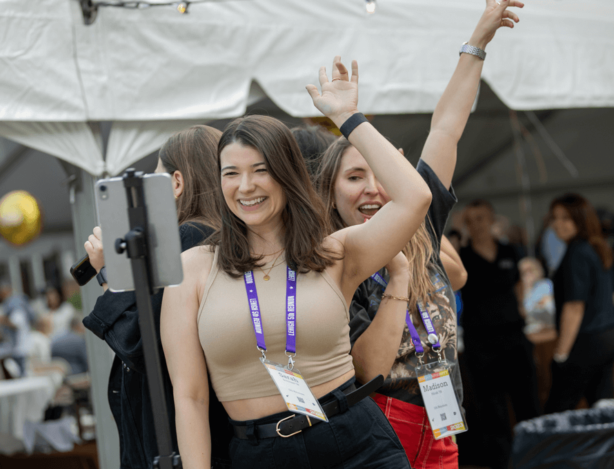 A small group of women dancing and posing for a 360 degree camera at a outdoor Reunion event.