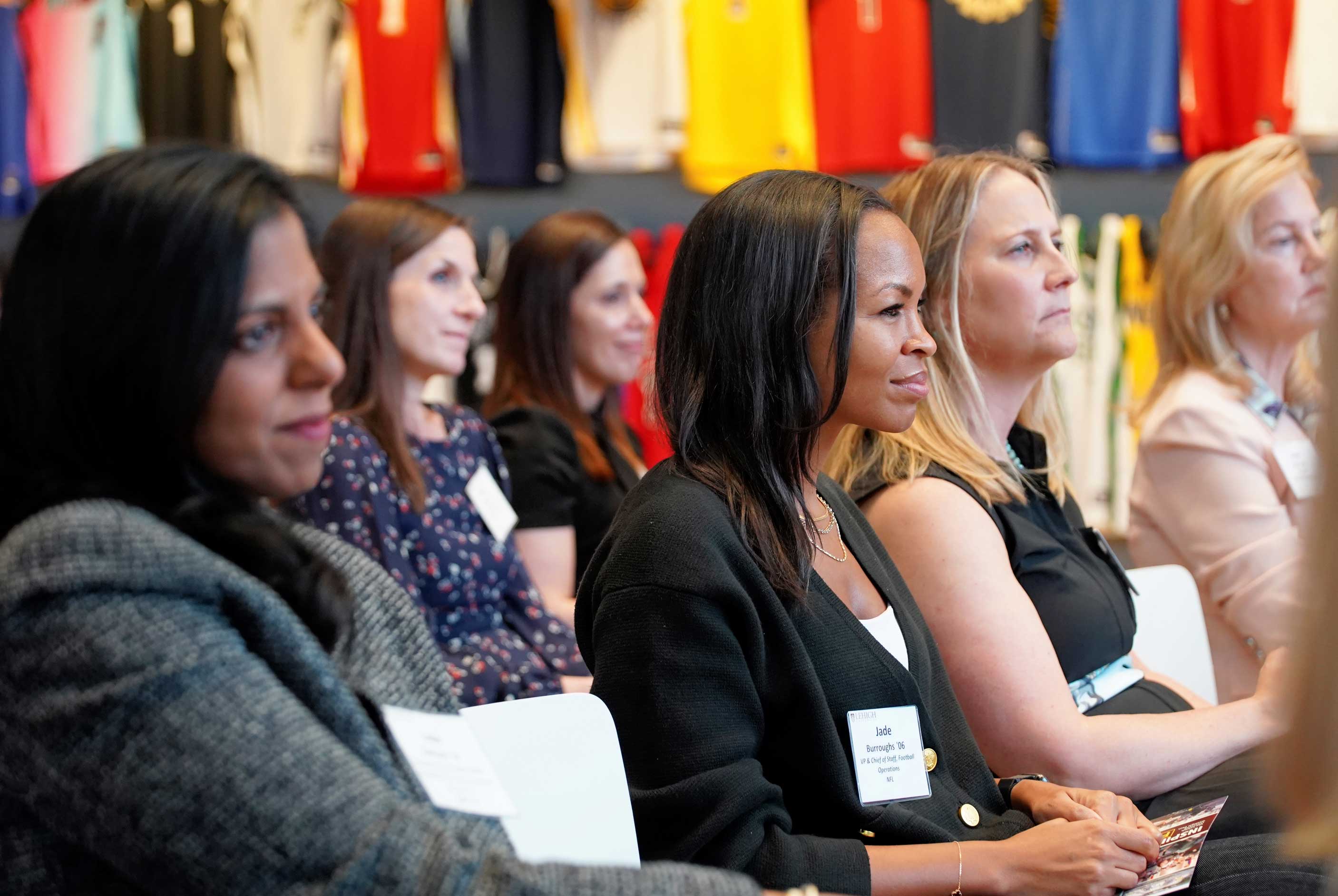 Women sitting for a presentation, listening intently.