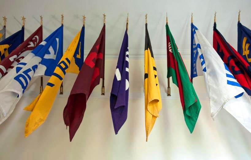 Colorful Lehigh class flags lined up along a wall.