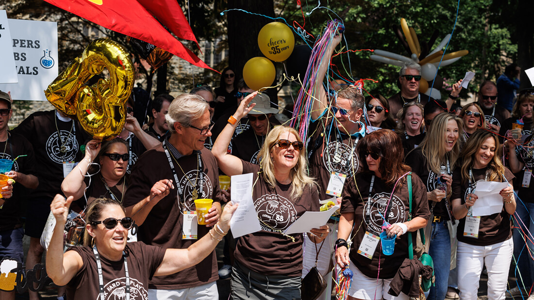 a crowd of people celebrating during the Parade of Classes during Reunion
