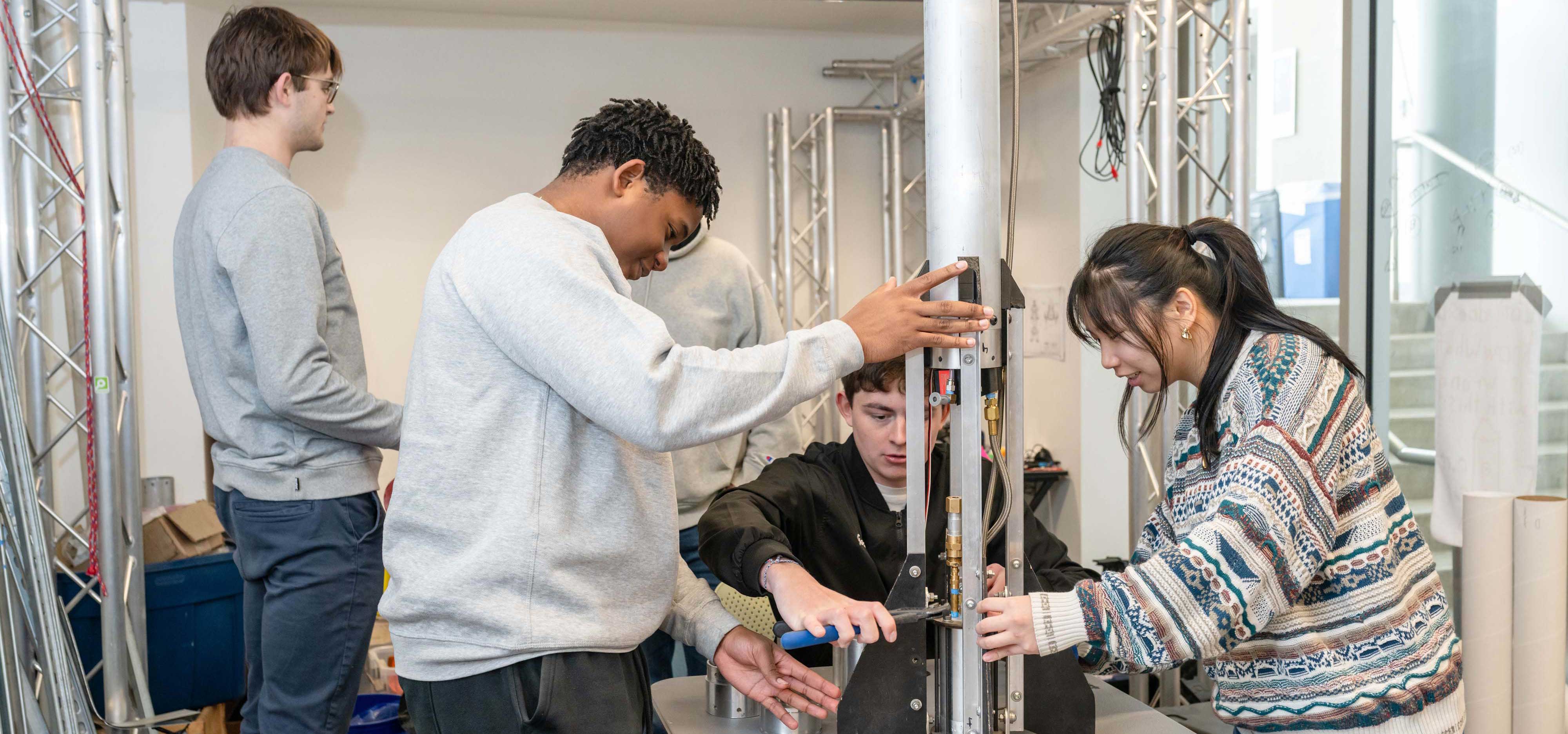 Students work together on a metal project.