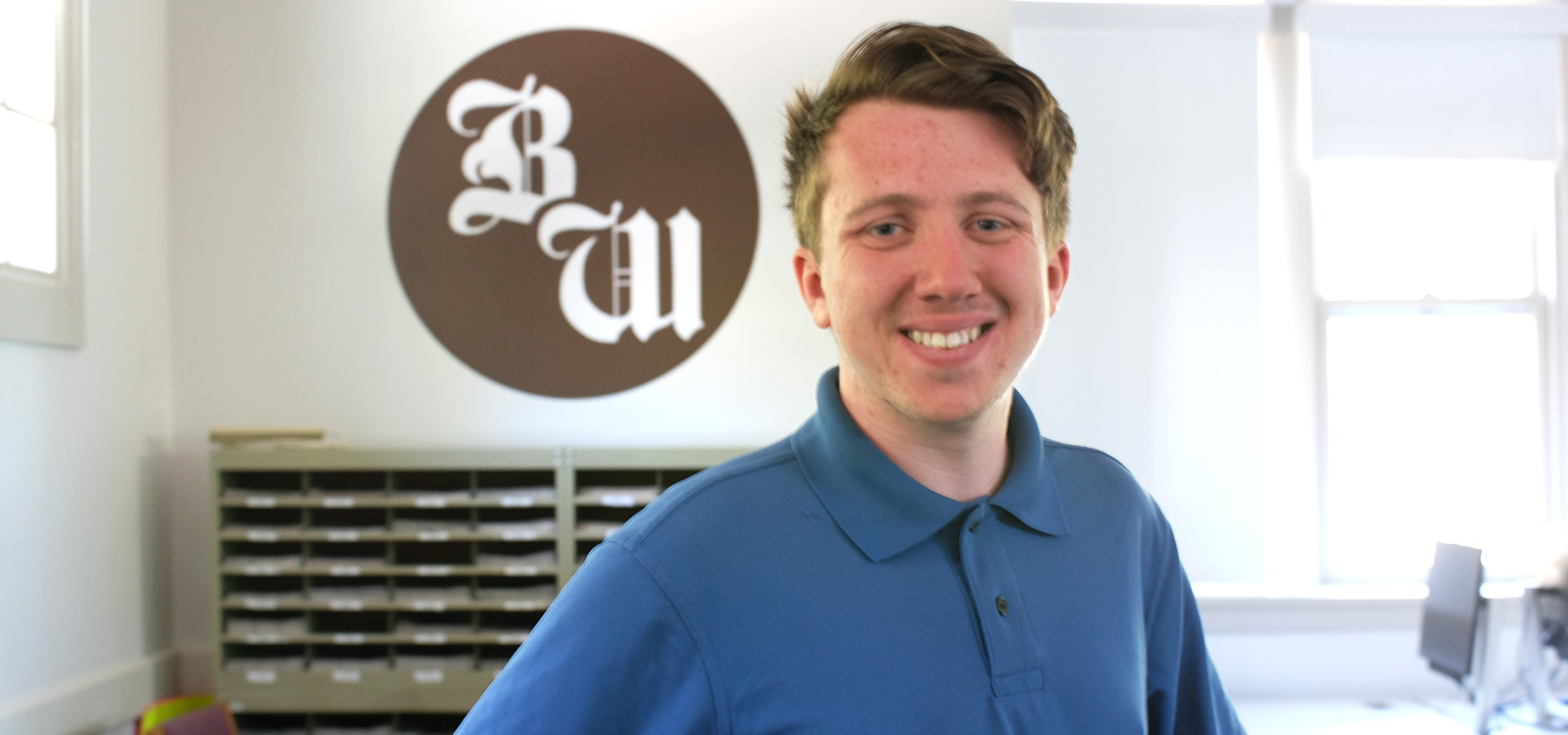 Eddie Fuhrer stands inside The Brown and White office.