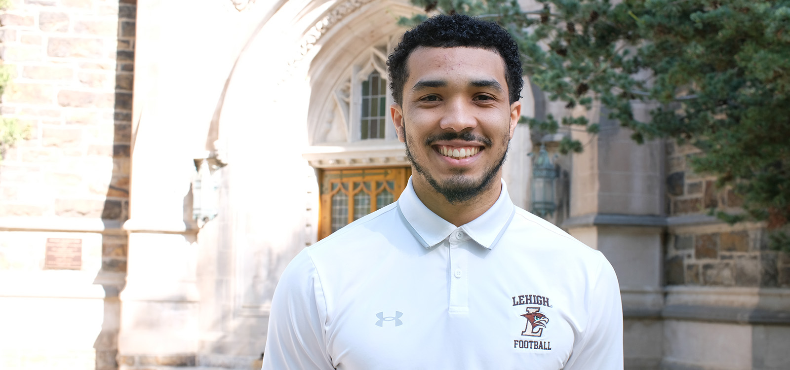 Harrison Jenkins wears a Lehigh football shirt in front of Packard Lab