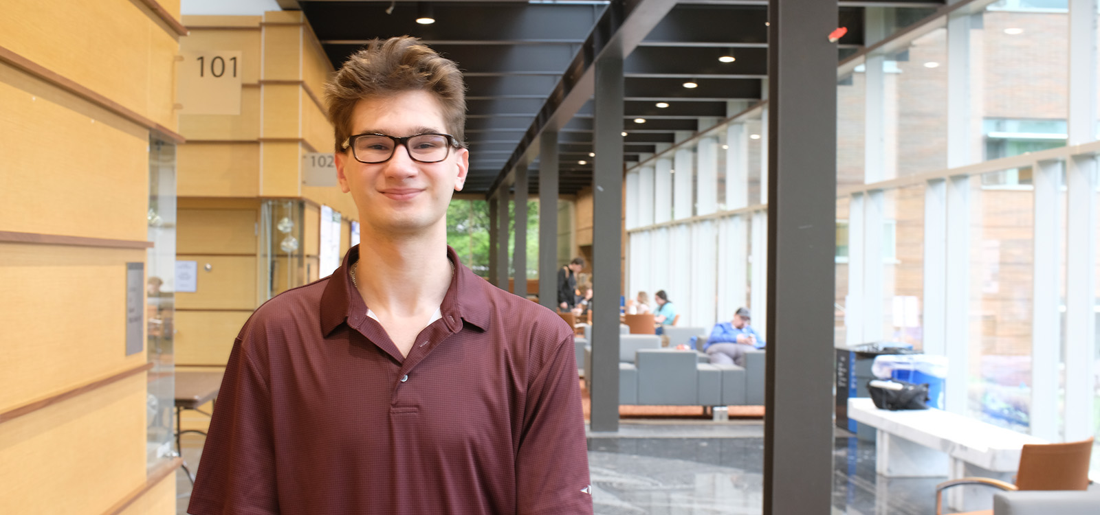 Zachary Porter stands inside Steps atrium