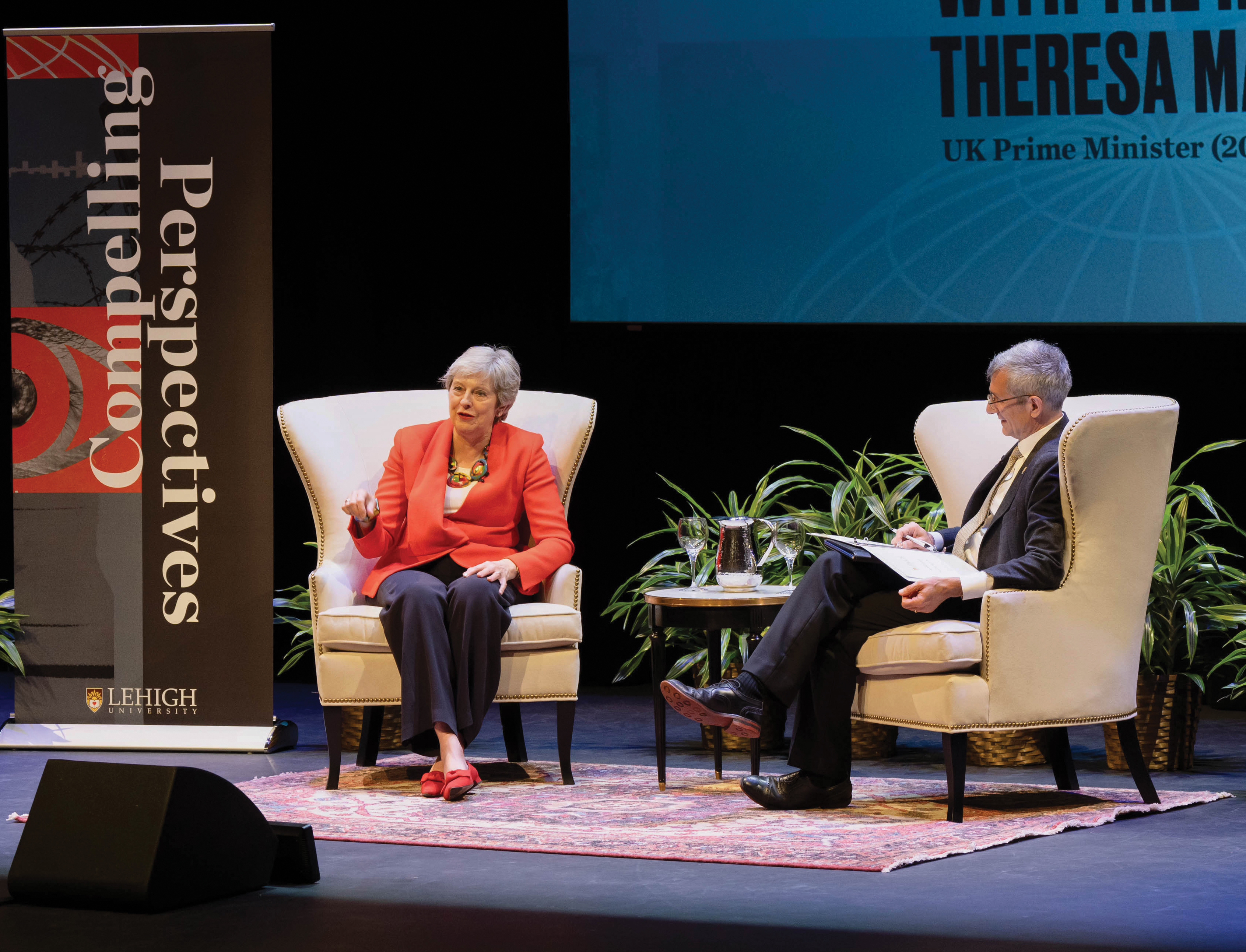 Theresa May and President Helble sitting on a stage for a panel discussion during Compelling Perspectives.