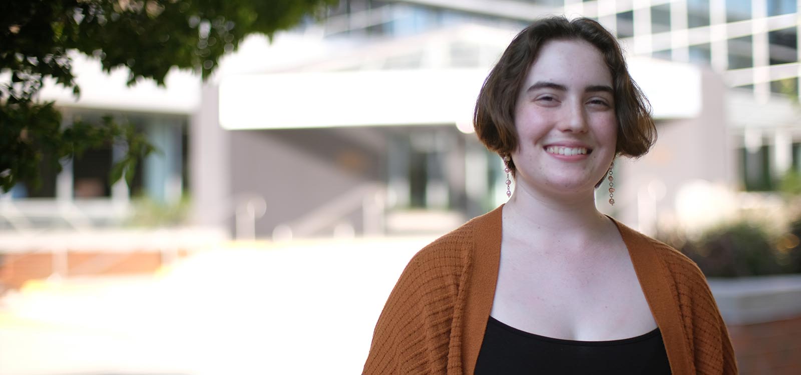 Sofee Rieker stands in a cardigan near the library.