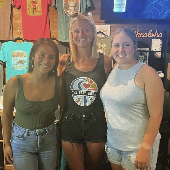 Bartlett wearing a The Next Swell tank top, poses with friends at a TNS fundraising event