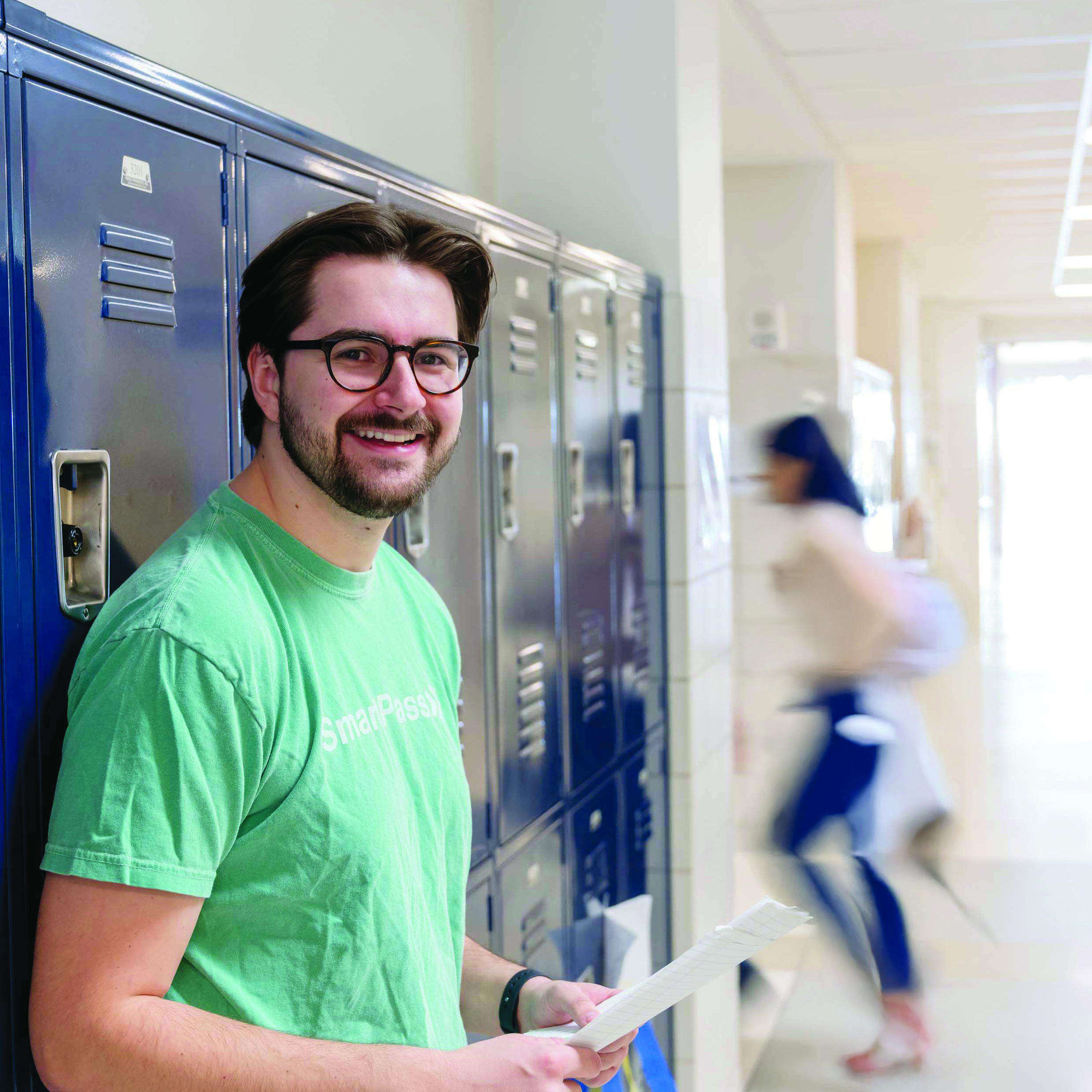 Peter Luba stands in a hallway and leans against a row of lockers.