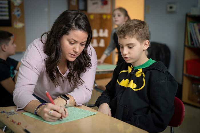 A teacher assisting a student with their assignment.