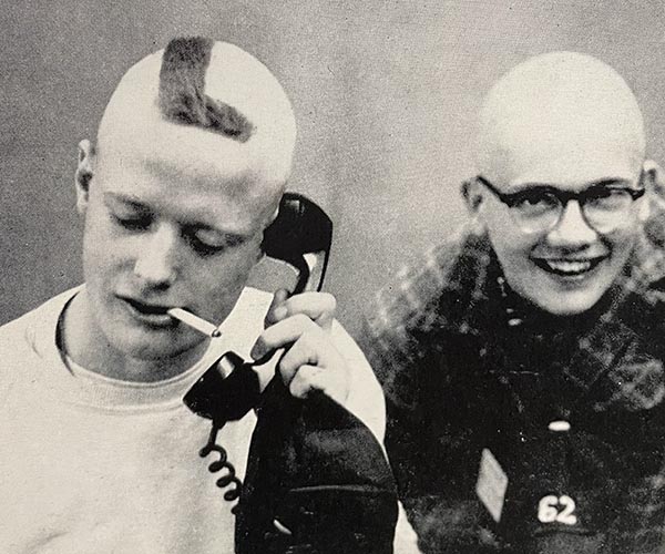 One freshman from the 1950s has an L shaved in his head while another is bald.