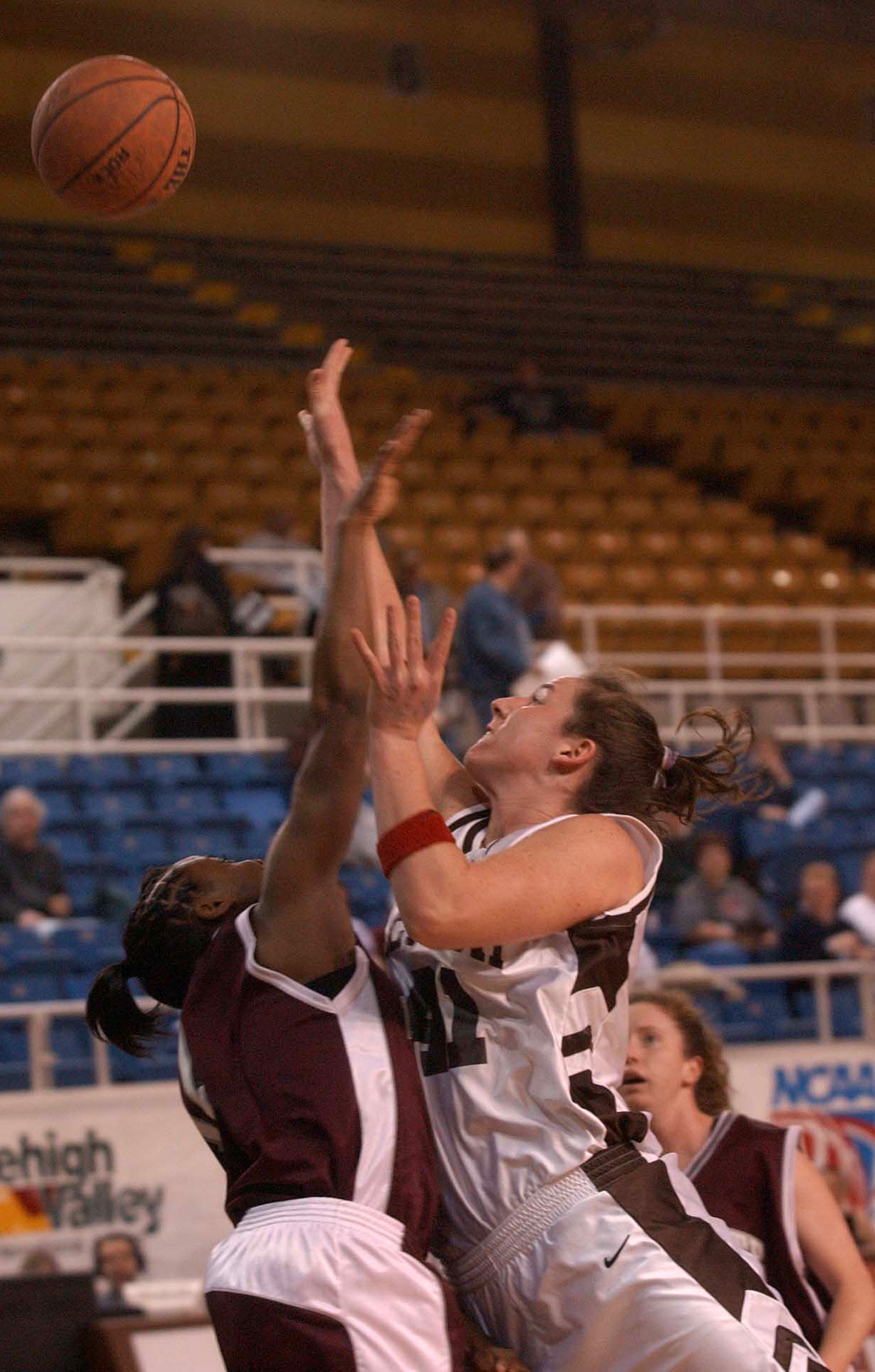 Anne Tierney jumps above an opponent on the basketball to retrieve a rebound.