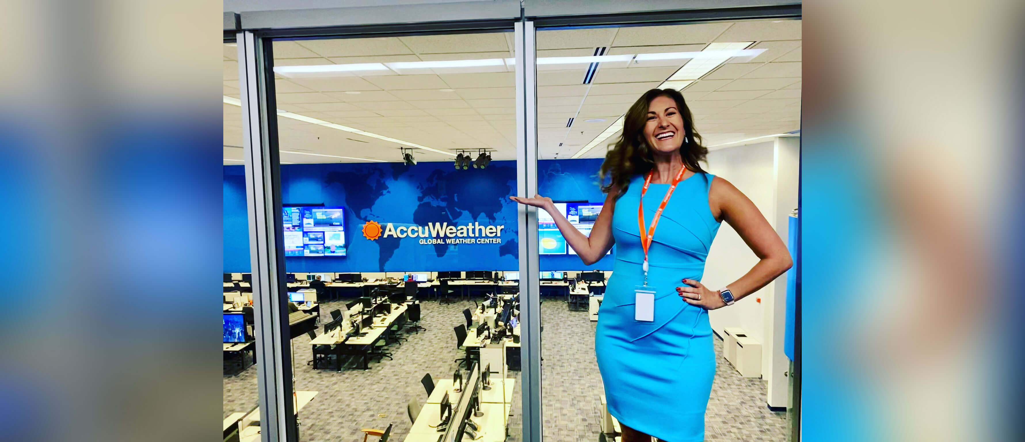Ariella Scalese poses in front of a newsroom.