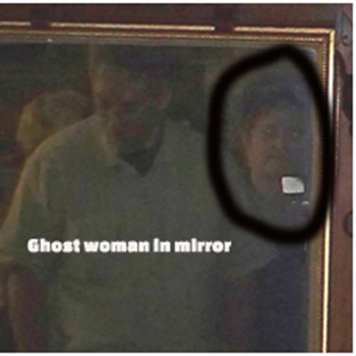 A mirror that shows a person standing before it as well as the face of female spirit tied to the mirror.