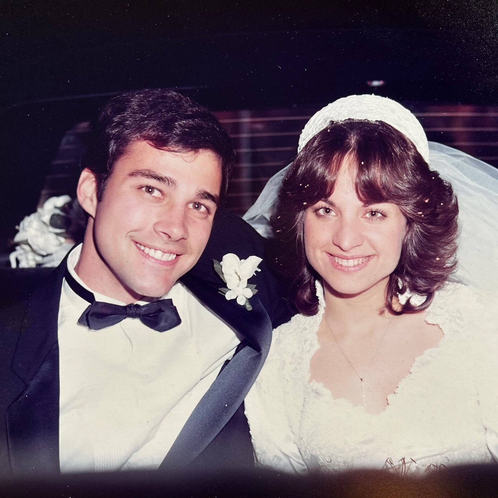 Fran and Tom Bartlett on their wedding day, showing from their chest up, wearing wedding attire.