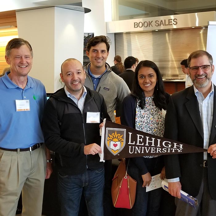 Lehigh folks involved with project pose with Lehigh pennant