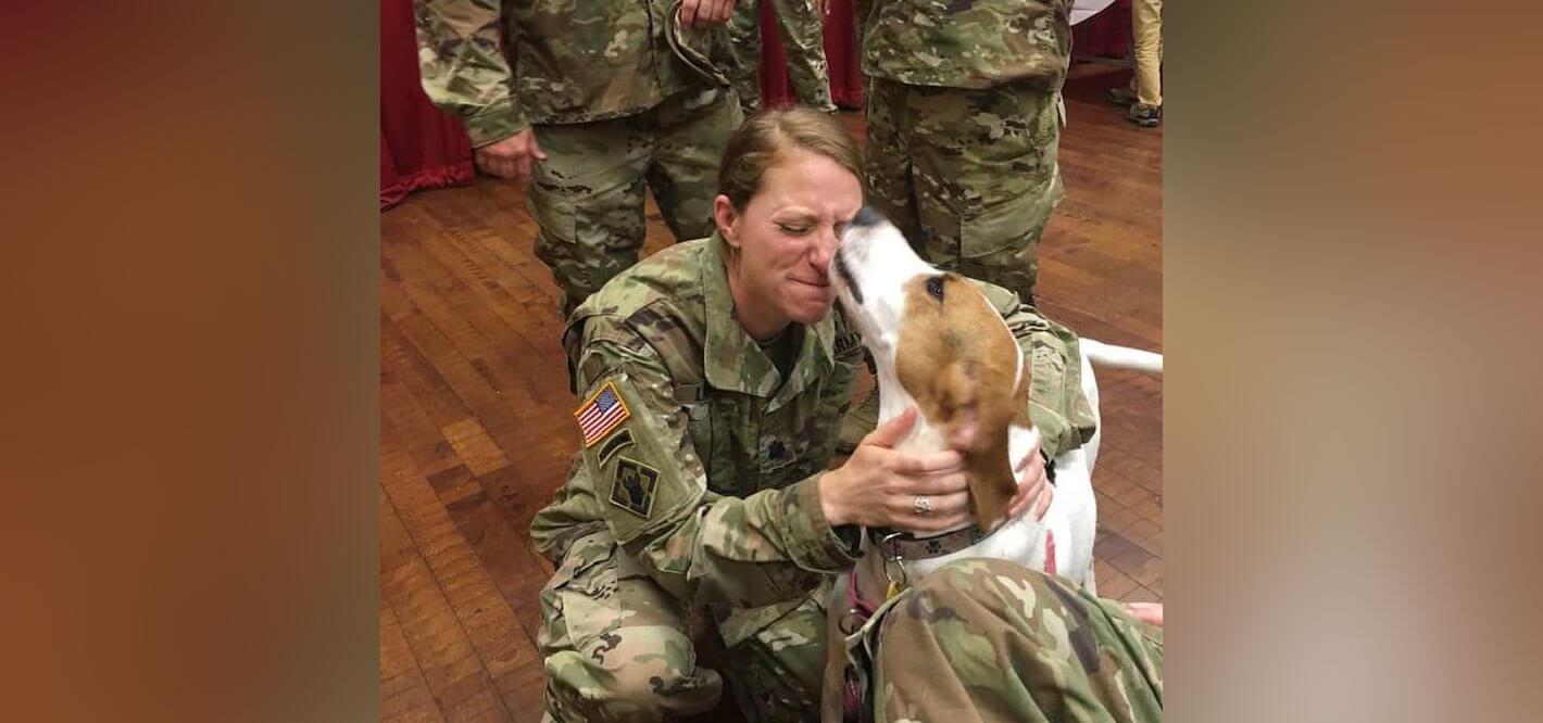 Becky Lapidow ’03 says goodbye to her dog, Lucy, before deployment to Kosovo in 2019.