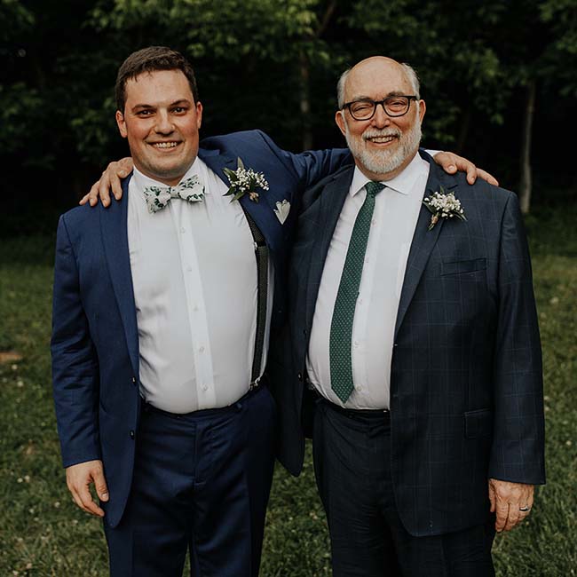 Dan and Dave Ingram in tuxedos with arms around each other's shoulders