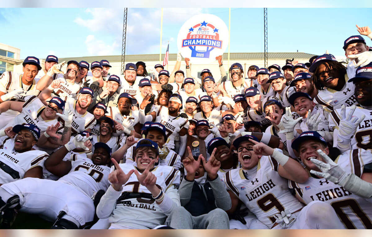 Lehigh football players in white uniforms poise for a group photo and hold a "Patriot League Champions" sign.