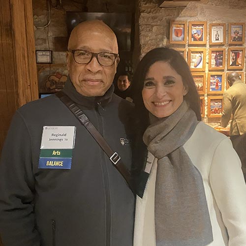 Reginald Jennings ’70 stands with an alumna at an event.
