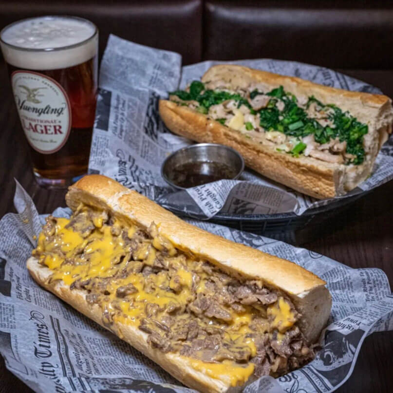 Cheesesteak with whiz and fried onions, roast pork with broccoli rabe, cooper sharp cheese, and a pint of Yuengling
