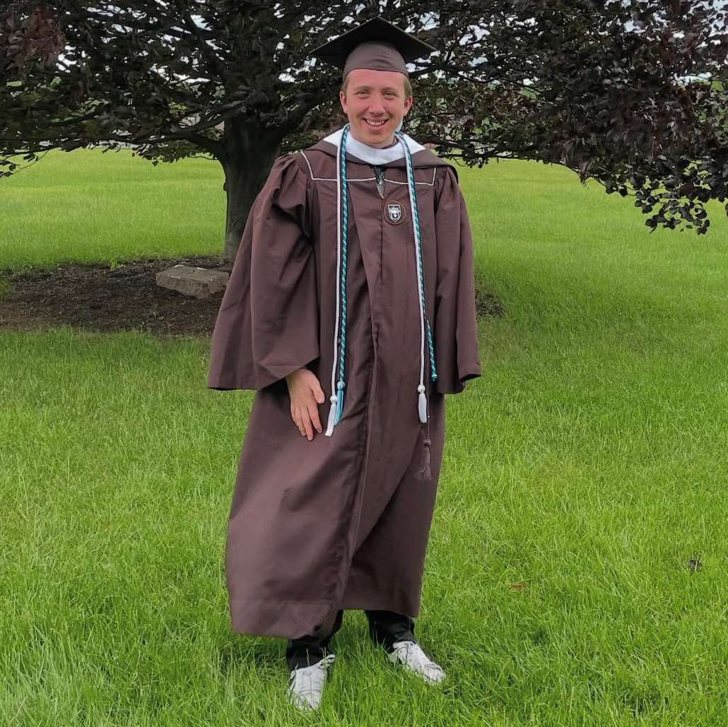 Eddie smiles in his Lehigh graduation cap, gown, and cords.