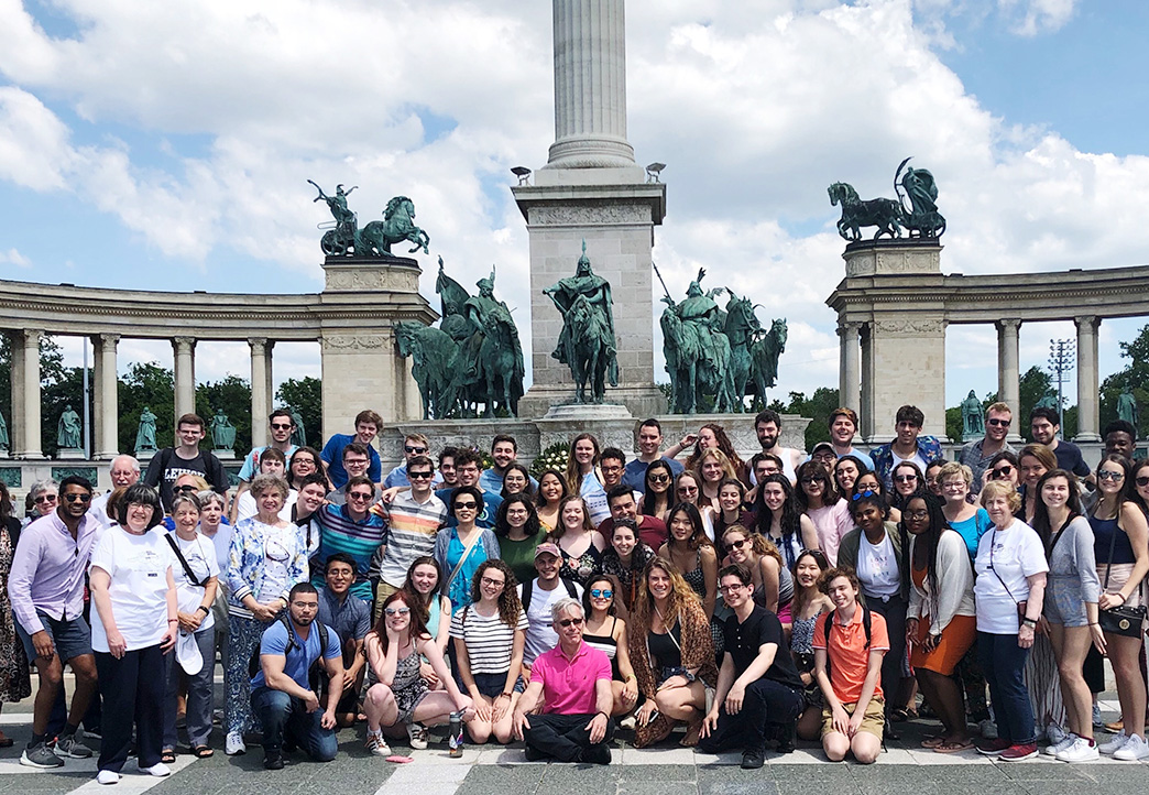 Emily Winn-Deen '74 stands with 100 other student and alumni members of the choice at Hero's Square in Budapest, Hungary