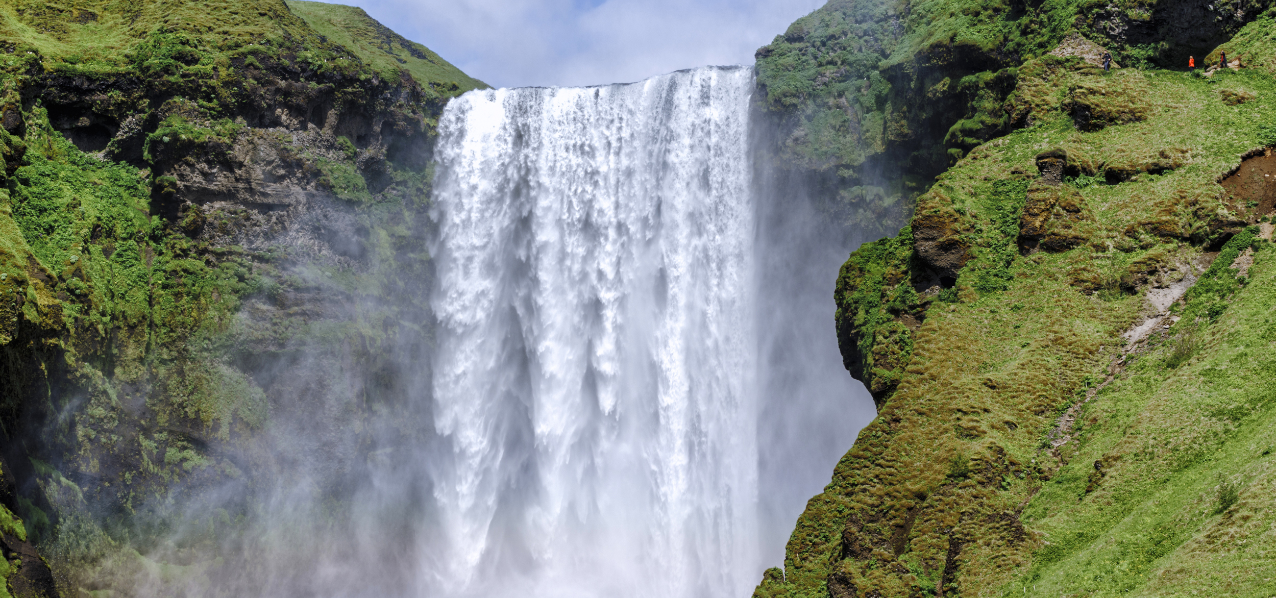 A waterfall framed by mossy cliffs and rocks