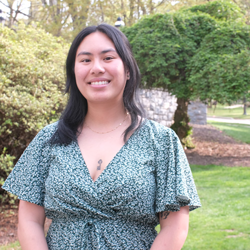 Diana Nguyen ’25 wears a green dress near Packard Memorial.