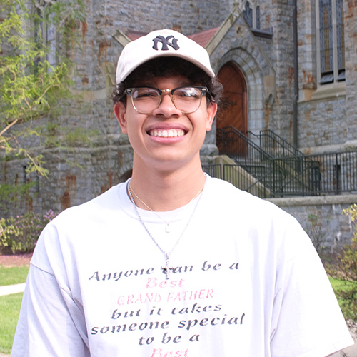 Kevin Dotel '25 wears a Yankees hat near Packer Memorial Church