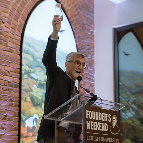 President Joseph Helble raises a glass to toast the newly dedicated Clayton University Center