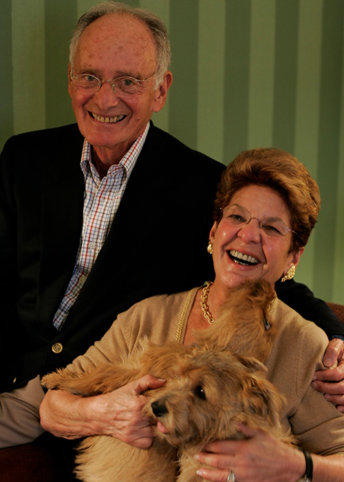 Don and Judy Gruhn sitting together with their dog