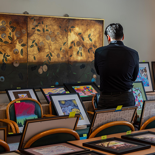 Judge stares at tables full of art to decide what might be included in the show