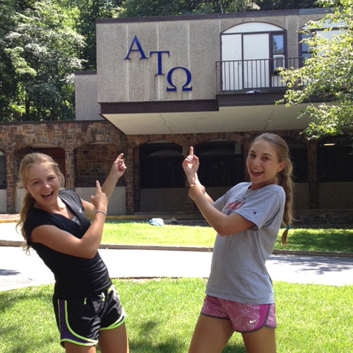 Hite grils point at their father's fraternity house
