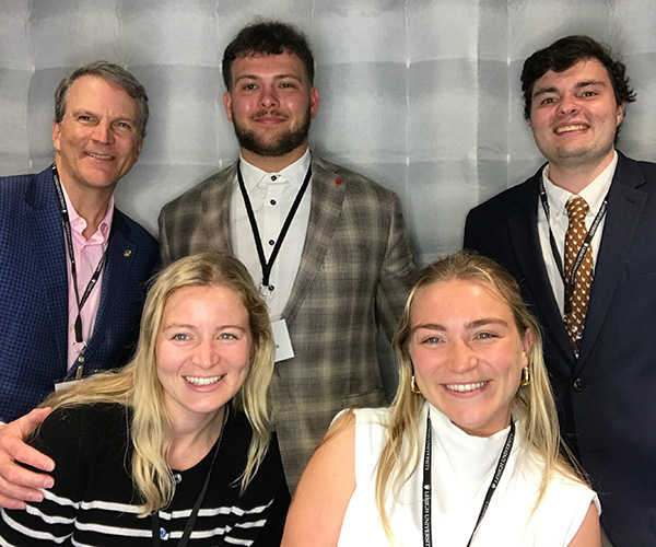 The Hite family pose with two Lehigh student athletes