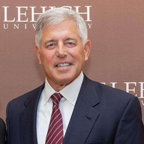 Howard in a navy sport coat with a Lehigh backdrop