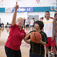 Annette Lynch coaching a Special Olympics player.