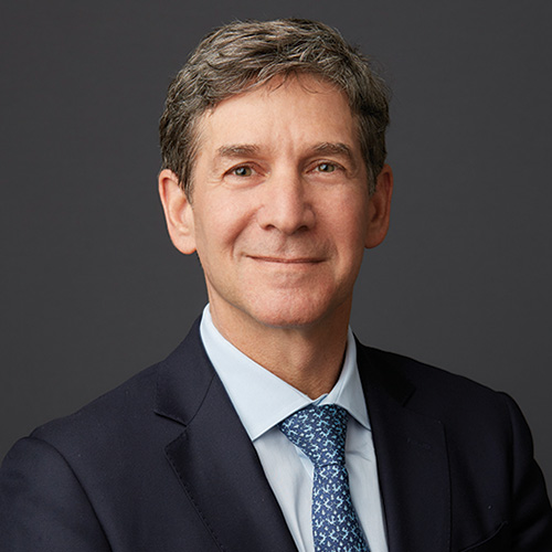 Jon Ballis in a navy suit and tie