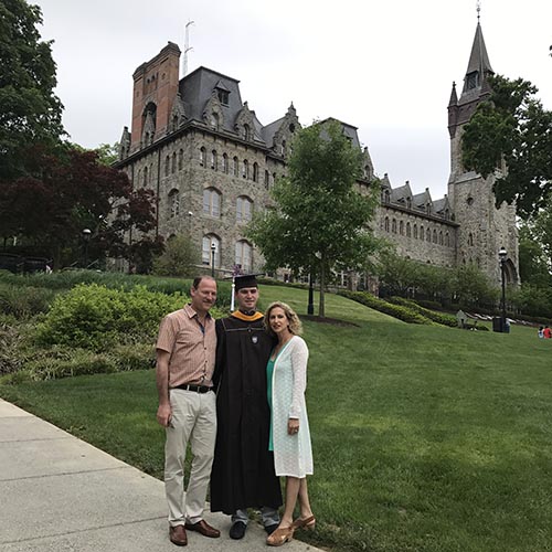 Kyle and David Greenberg stand with their son Henry at his Lehigh graduation