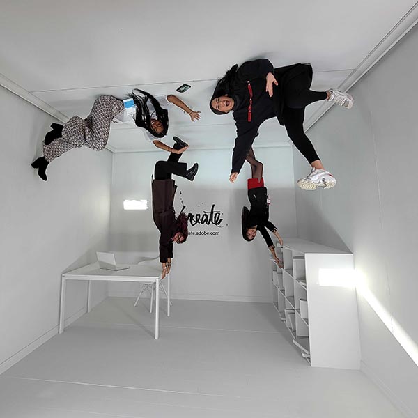 Four students appear upside down in a office