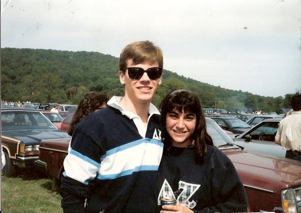 Rau and a friend wear blue fraternity letters on their shirts at a tailgate
