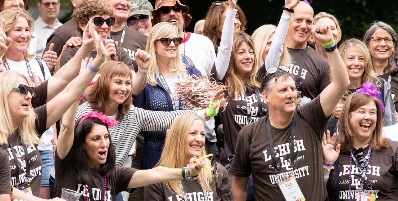 Alumni cheering and wearing Lehigh gear